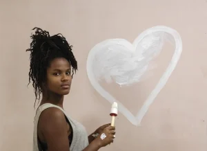 teenager painting on a wall