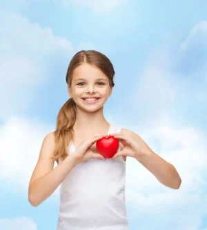 shirt design, health, charity, love concept - smiling teenage girl in blank white shirt with small red heart